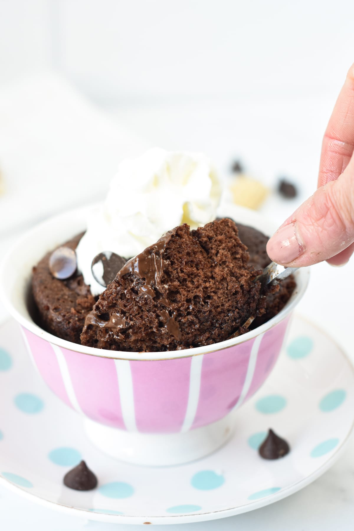 3 ingredients Keto Mug Cake in a mug with a spoon digging into it.