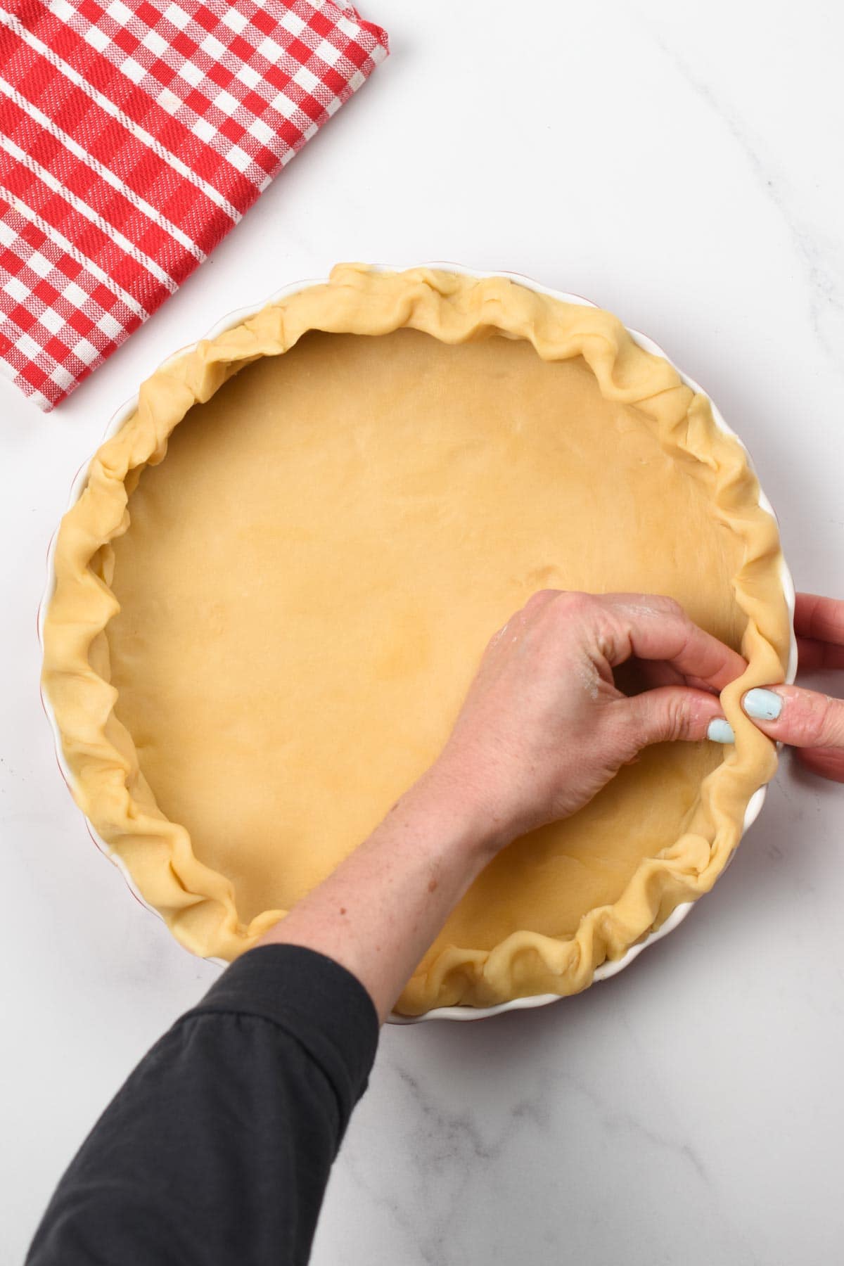 Pressing the 3-ingredient Pie Crust into the pan manually.