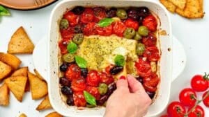 This Baked Feta Dip is a the most delicious hot dip with Meditareean flavors. A creamy cheese feta dip baked with olives, roasted cherry tomatoes and garlic.