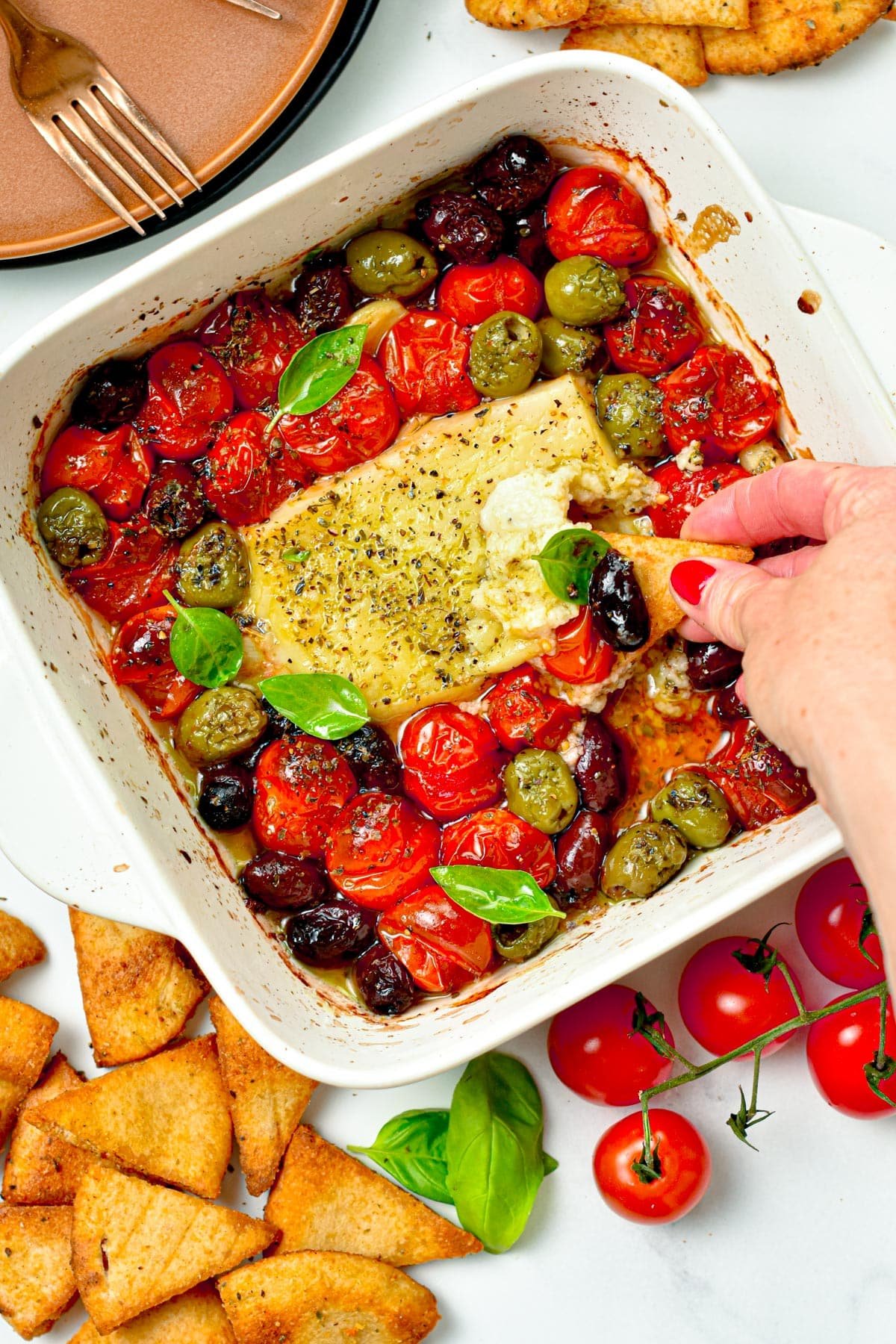 This Baked Feta Dip is a the most delicious hot dip with Meditareean flavors. A creamy cheese feta dip baked with olives, roasted cherry tomatoes and garlic.