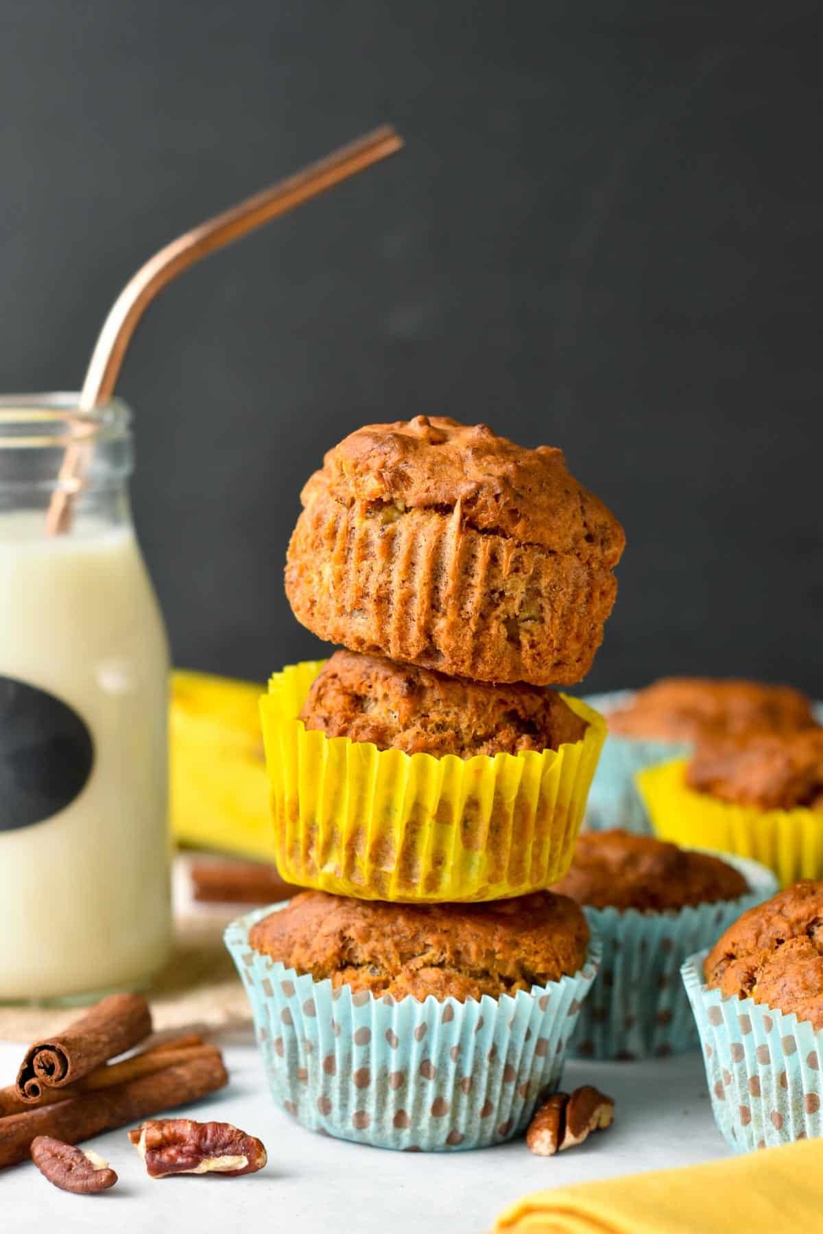 Banana Bread Muffins stacked next to a jar of almond milk