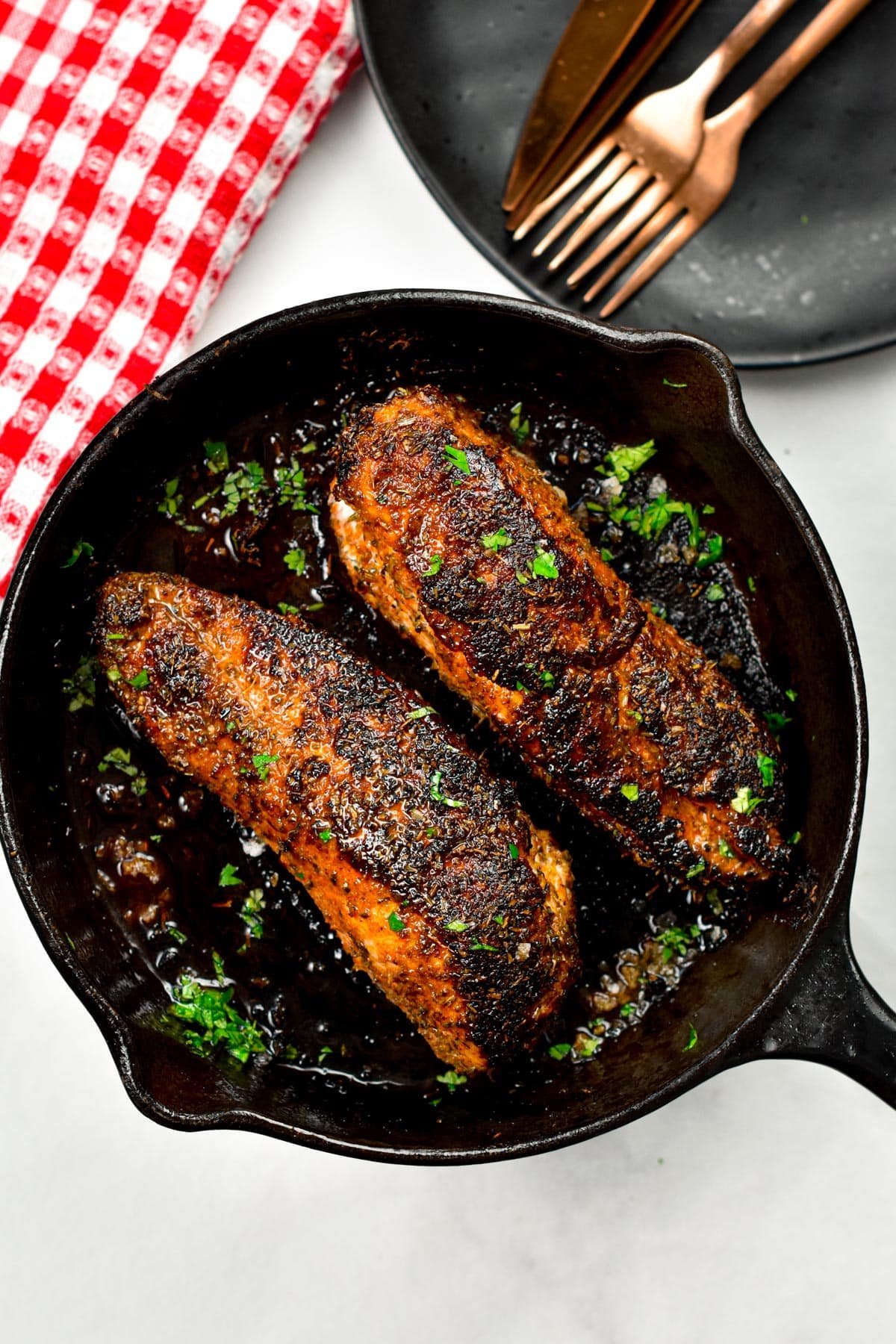 Blackened Chicken cooked in a large cast-iron pan.