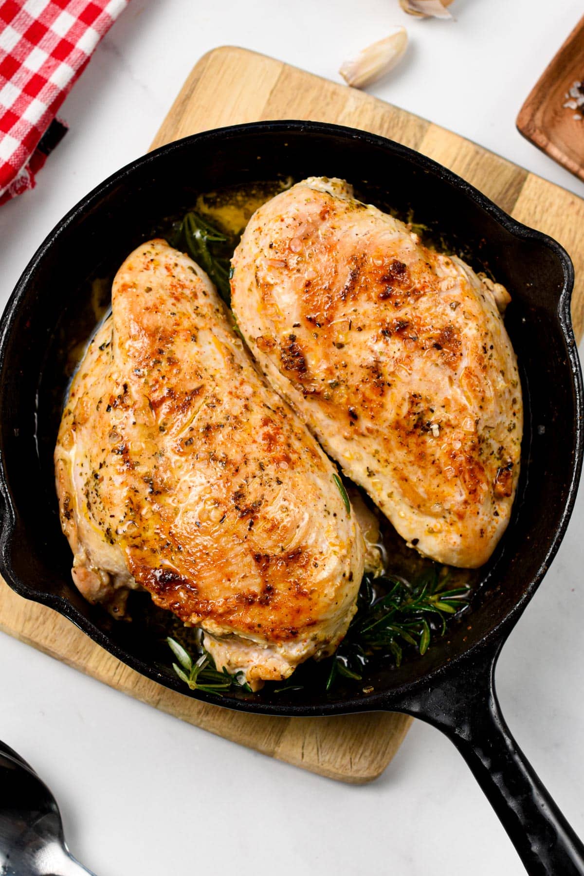 Two Cast Iron Chicken Breast cooked on a cast-iron pan.