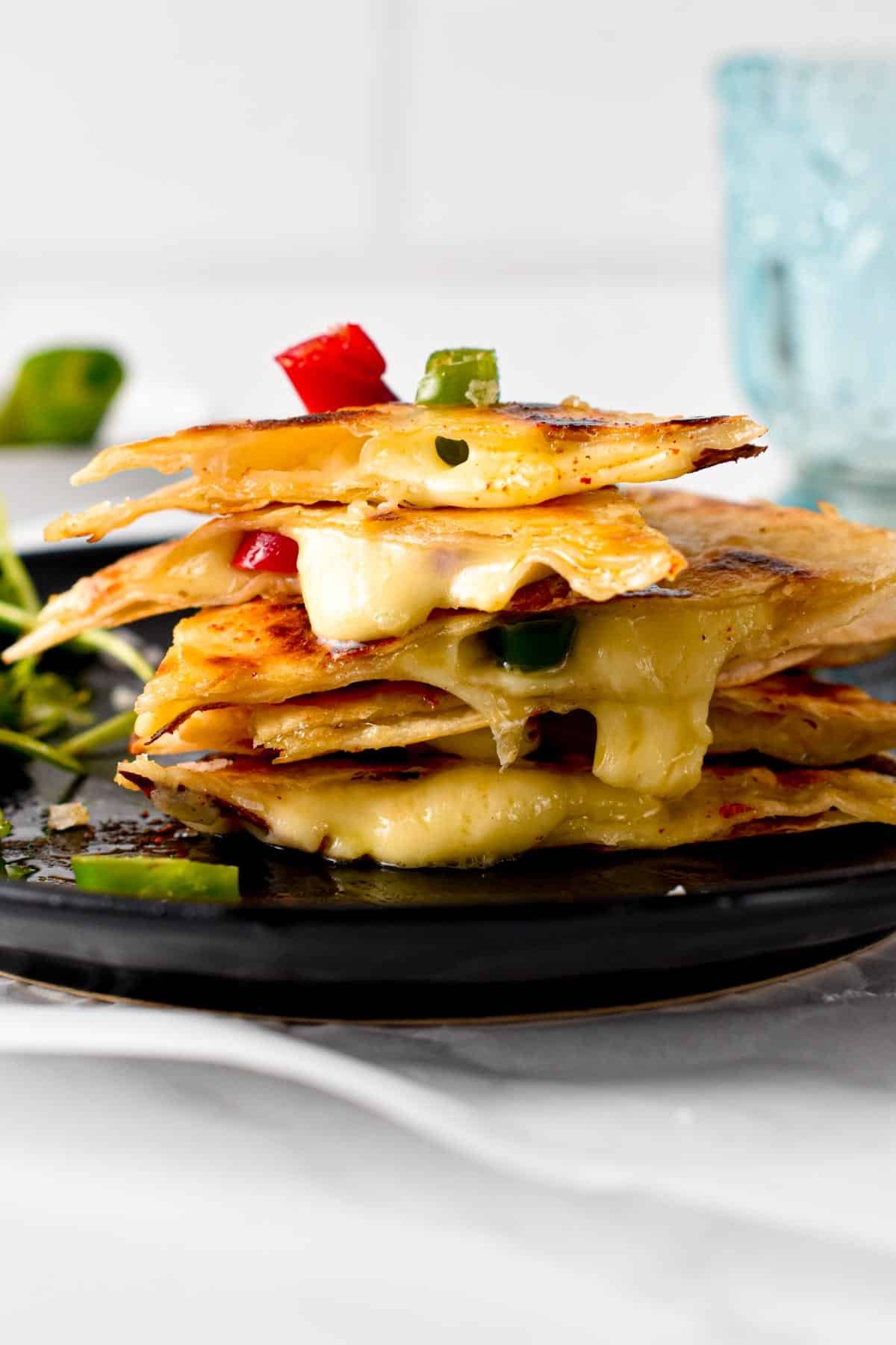 This easy Cheese Quesadilla also called Queso quesadilla is a crispy flour tortilla filled with stringy melted cheese and pieces of jalapeno. This is the perfect 10 minutes lunch for cheese lovers, easy to adapt by throwing in any extra vegetables or proteins you have on hand.