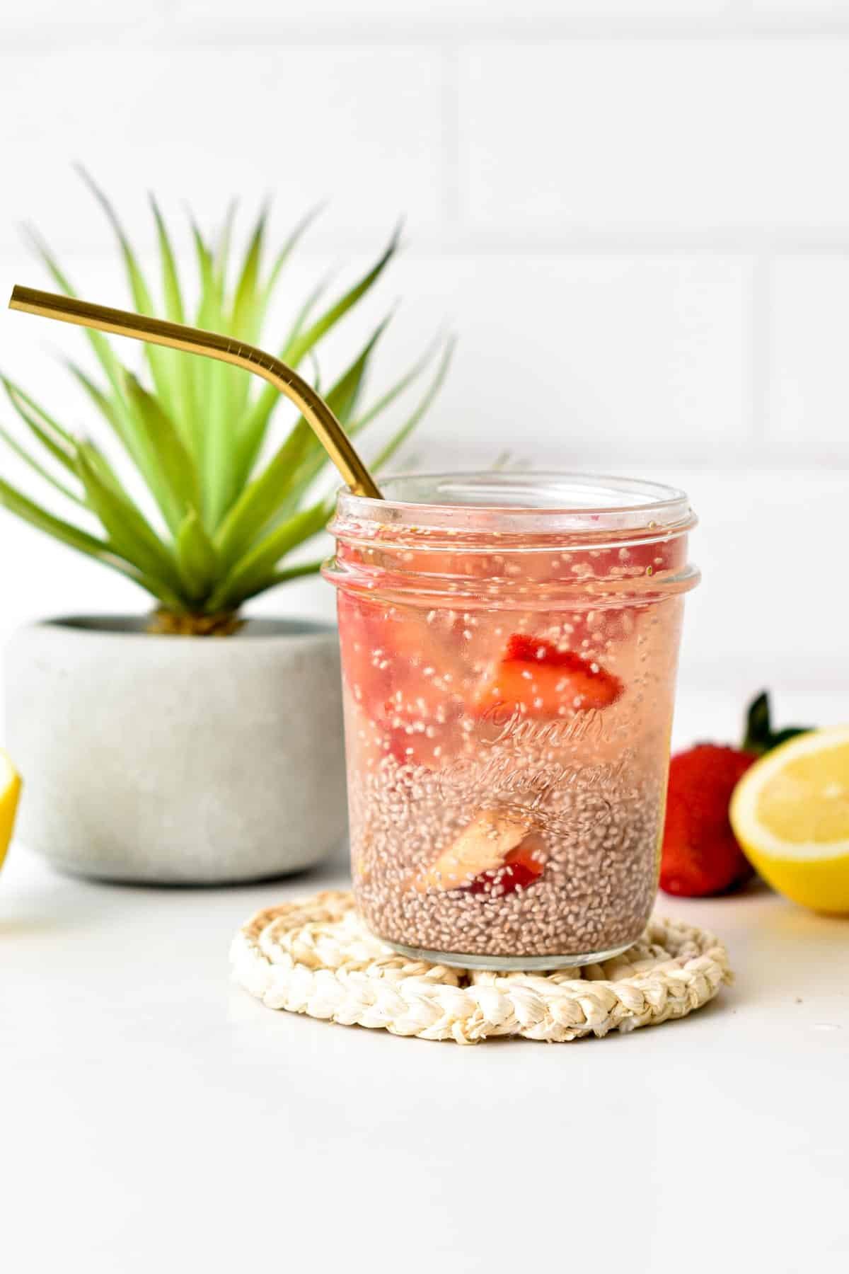 Chia Fresca in a jar with a golden straw.