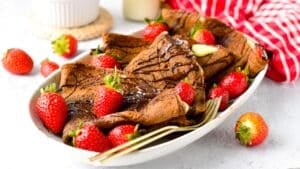 These Chocolate Crepes are thin chocolate French crepes perfect to fill with whipped cream, yogurt, or berries. It's an easy pancake recipe for breakfast or a delicious french dessert to impress.