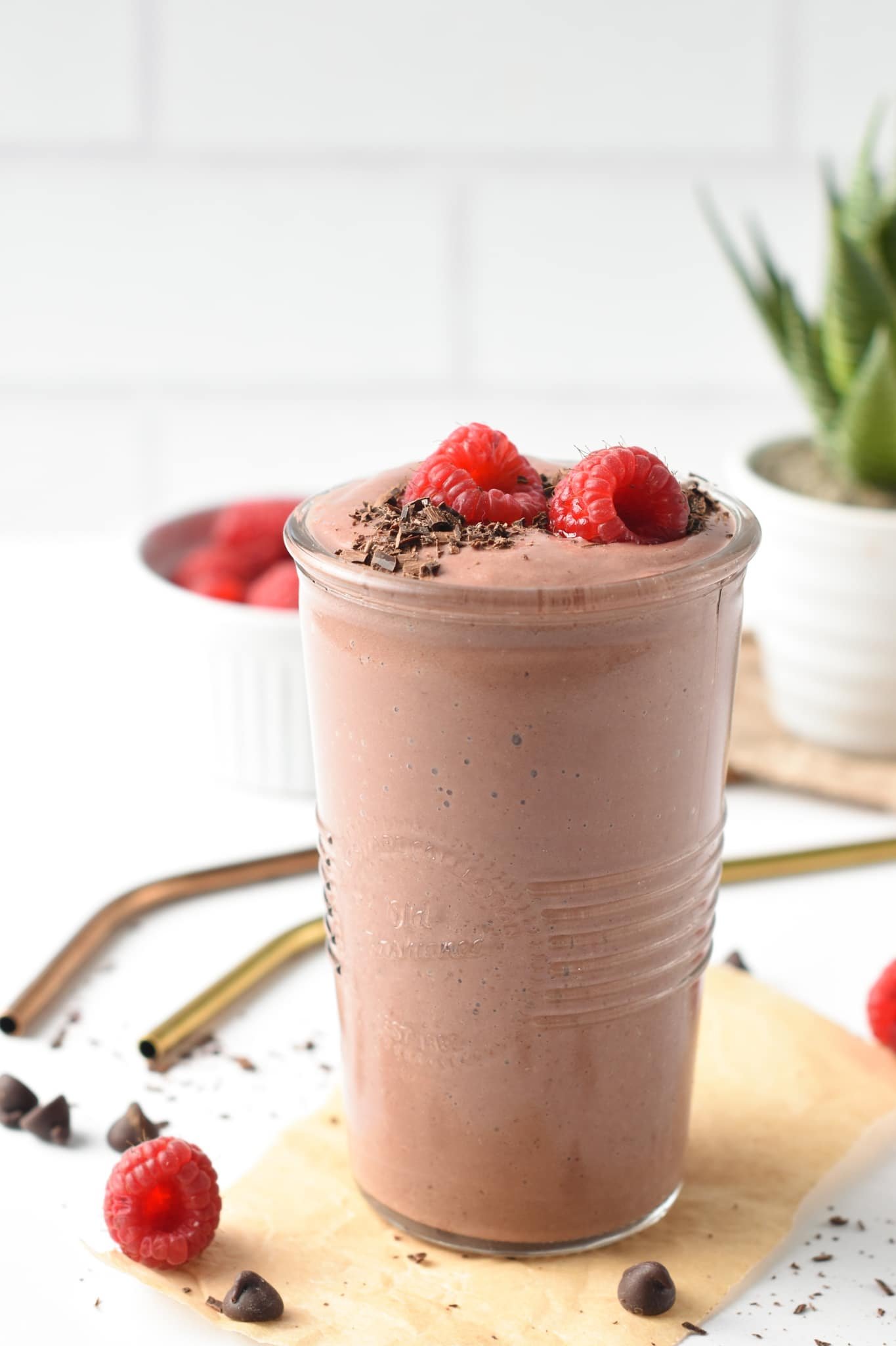 A thick, creamy, and decadent Chocolate Raspberry Smoothie with fudgy chocolate texture and fruity raspberry flavors.