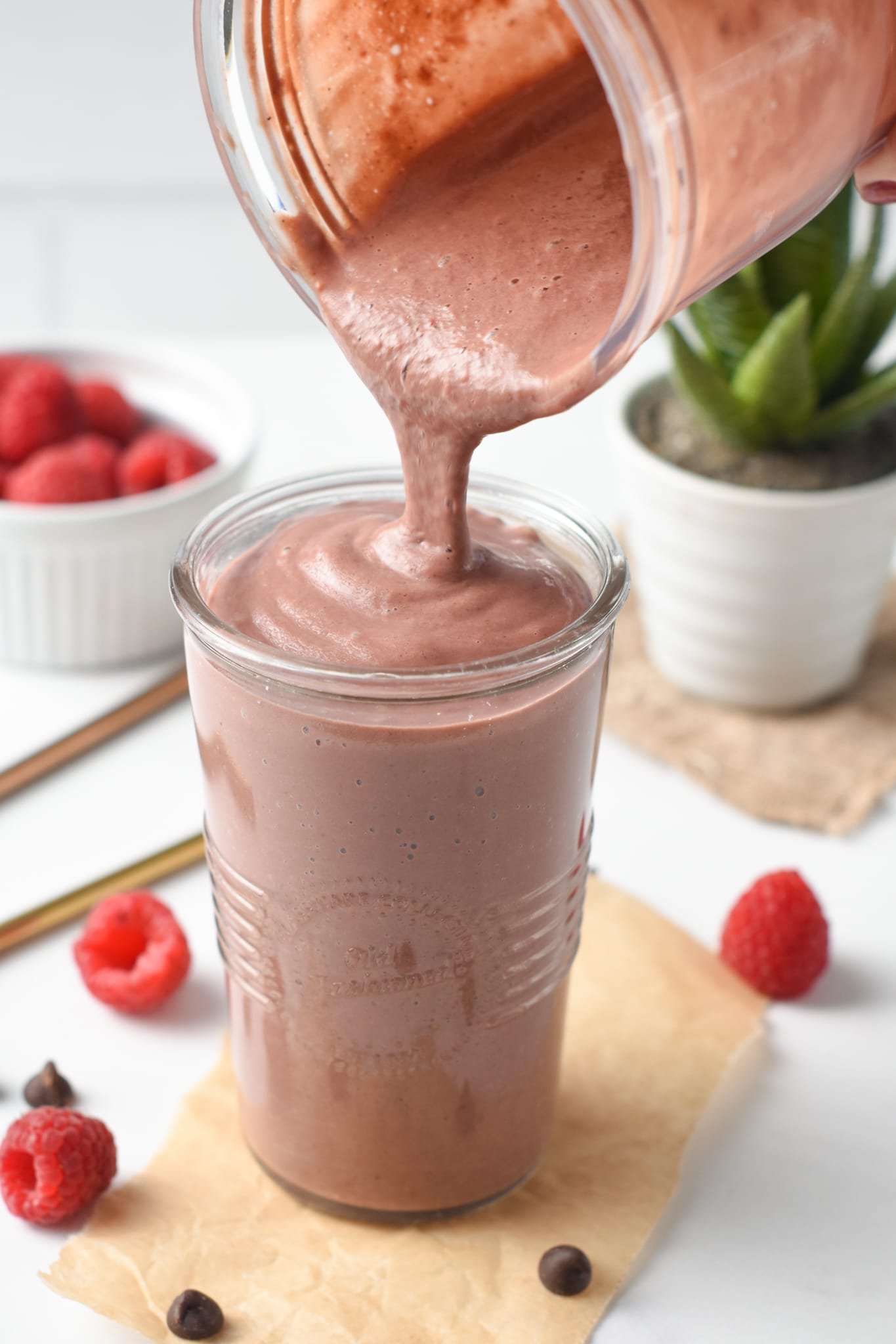 A thick, creamy, and decadent Chocolate Raspberry Smoothie with fudgy chocolate texture and fruity raspberry flavors.