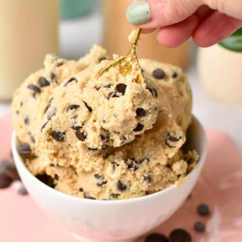 a golden spoon digging in a bowl filled with cottage cheese dough