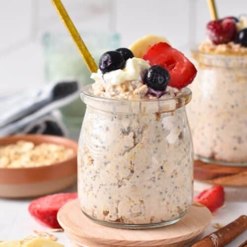 a jar of cottage cheese overnight oats with berries on top