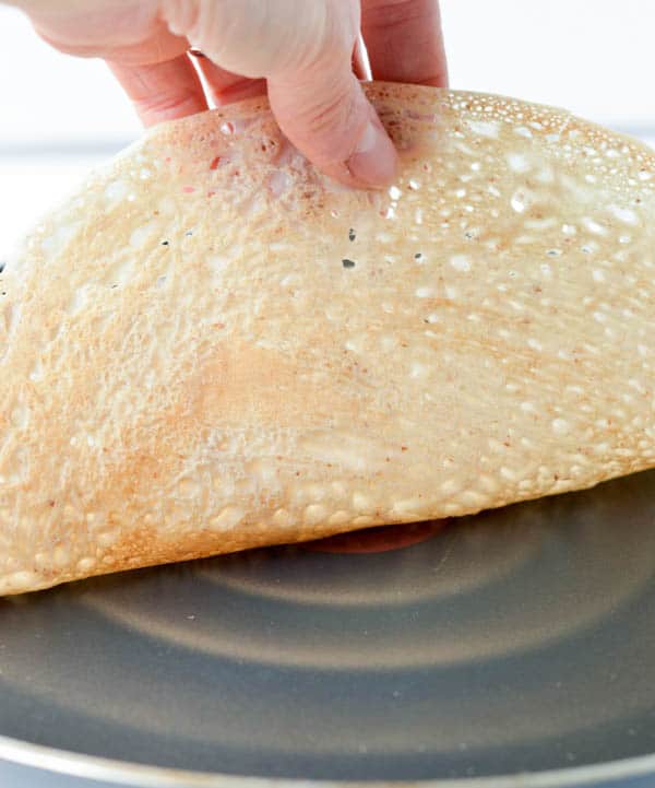 French Buckwheat Crepes are gluten free savory crepes made of 100% buckwheat flour, water, egg and salt. It is an easy and healthy 4 ingredients crepes recipe with moist center and crispy borders that French people love to eat for dinner stuffed with spinach and mushroom or ham and cheese.