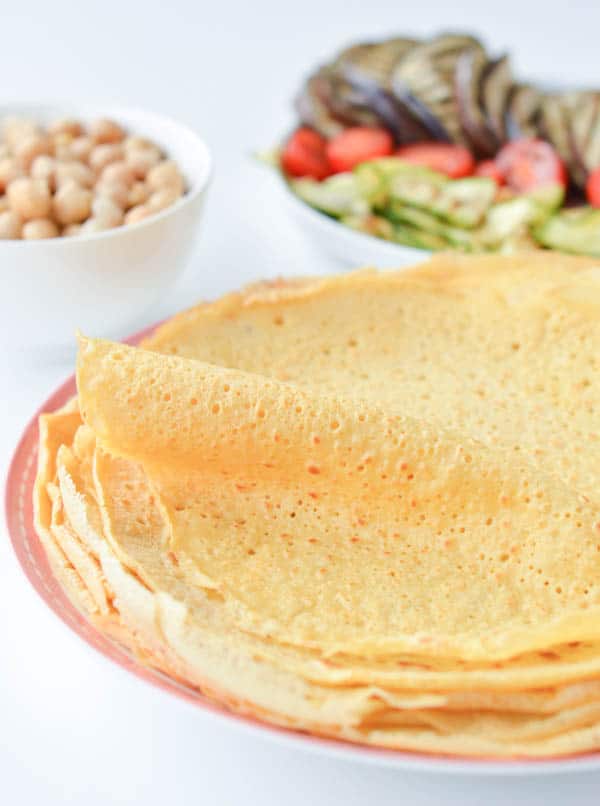 Chickpea crepes are delicious thin vegan and gluten free protein wraps made with only 3 ingredients: garbanzo bean flour, water and salt. An easy, healthy blender recipe perfect for a savory crepes for breakfast. Delicious with mushrooms, spinach or grilled vegetables. #vegan #chickpea #garbanzo #wraps