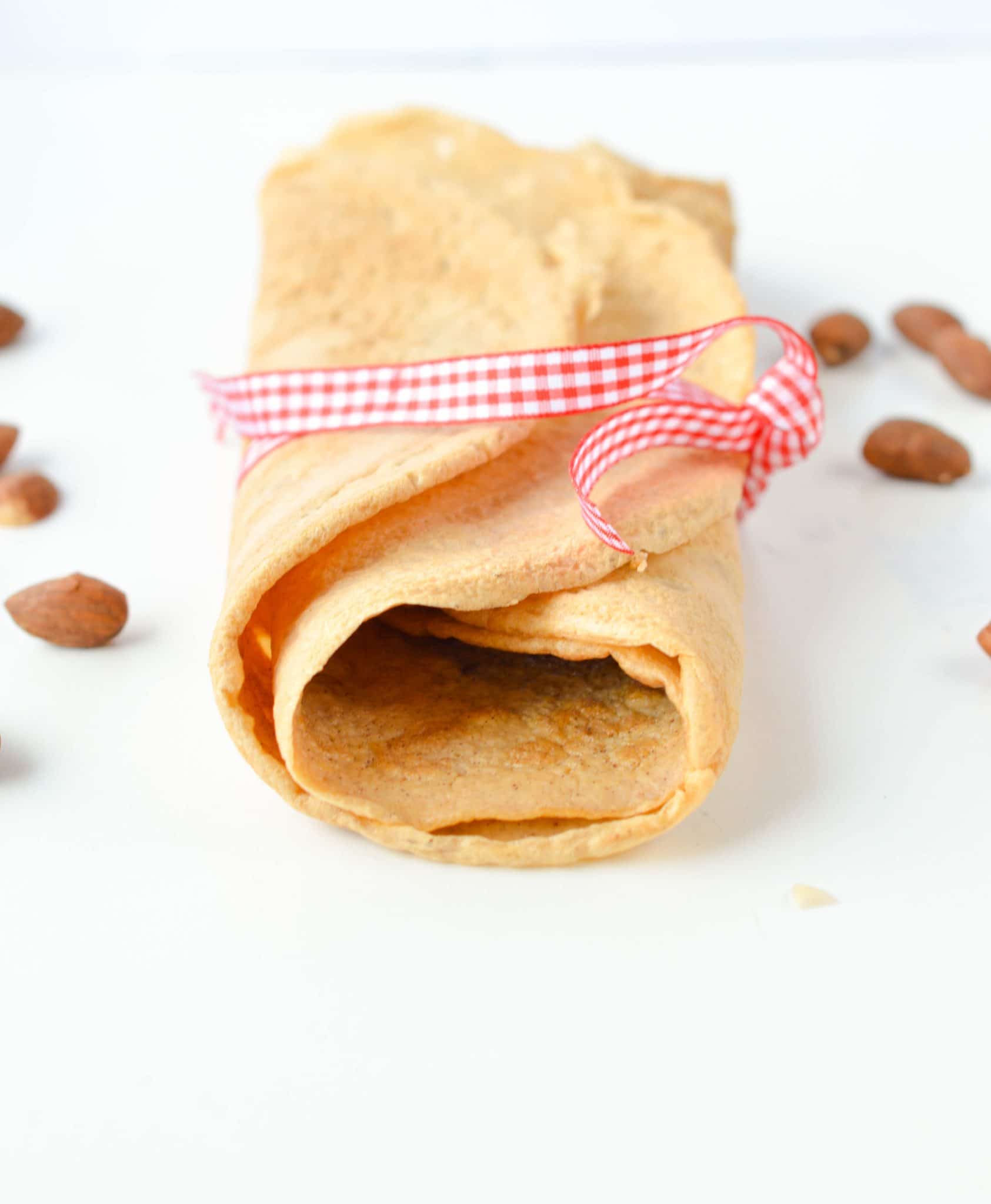 Almond Flour Crepes wrapped with a ribbon, decorated with almonds.