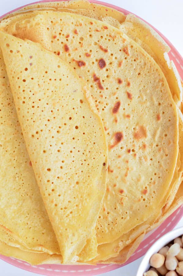 Chickpea crepes are delicious thin vegan and gluten free protein wraps made with only 3 ingredients: garbanzo bean flour, water and salt. An easy, healthy blender recipe perfect for a savory crepes for breakfast. Delicious with mushrooms, spinach or grilled vegetables. #vegan #chickpea #garbanzo #wraps