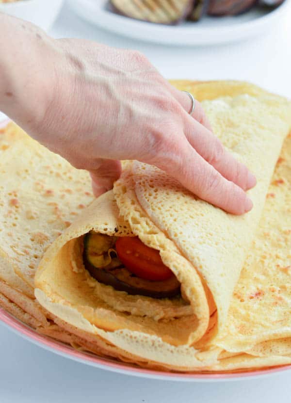 Chickpea crepes are delicious thin vegan and gluten free protein wraps made with only 3 ingredients: garbanzo bean flour, water and salt. An easy, healthy blender recipe perfect for a savory crepes for breakfast. Delicious with mushrooms, spinach or grilled vegetables. #vegan #chickpea #garbanzo #wraps