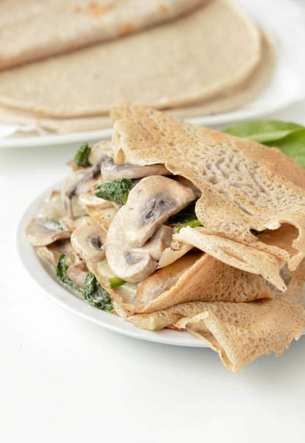 French Buckwheat Crepes are gluten free savory crepes made of 100% buckwheat flour. An easy, healthy 4 ingredients savory crepes recipe to stuff with ham and cheese or spinach and mushrooms. #crepes #buckwheat #glutenfree