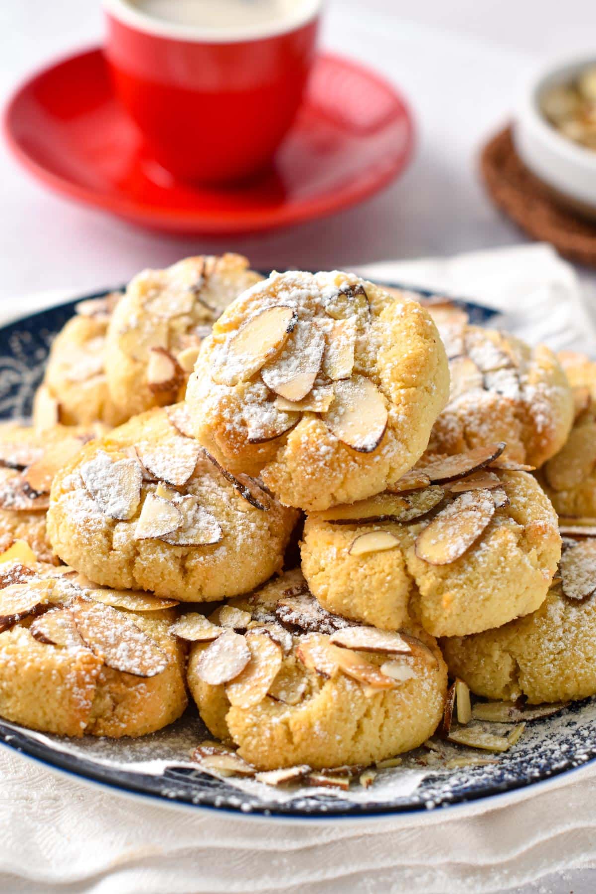 Greek Almond Cookies stacked on a plate.