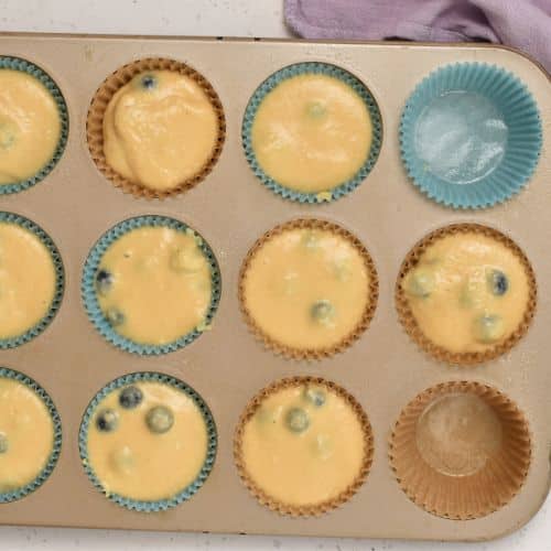 Transferring Greek Yogurt Protein Muffin batter into the muffin tin.