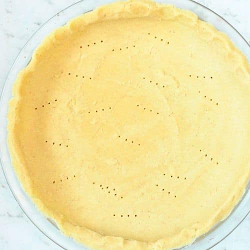 Pricked Keto Pumpkin Pie base ready to bake.