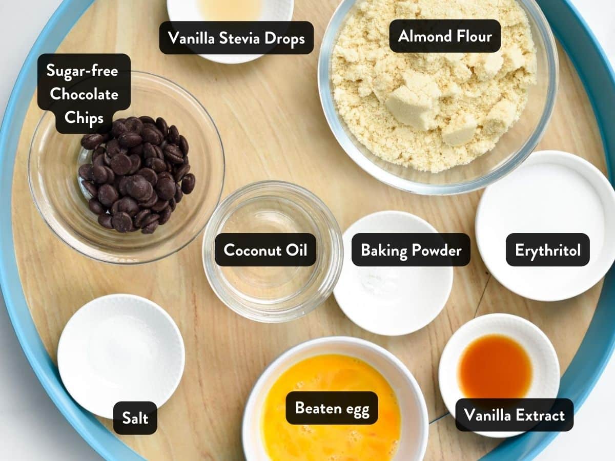 Ingredients for Keto Chocolate Chip Cookies in various bowls and ramekins with labels.