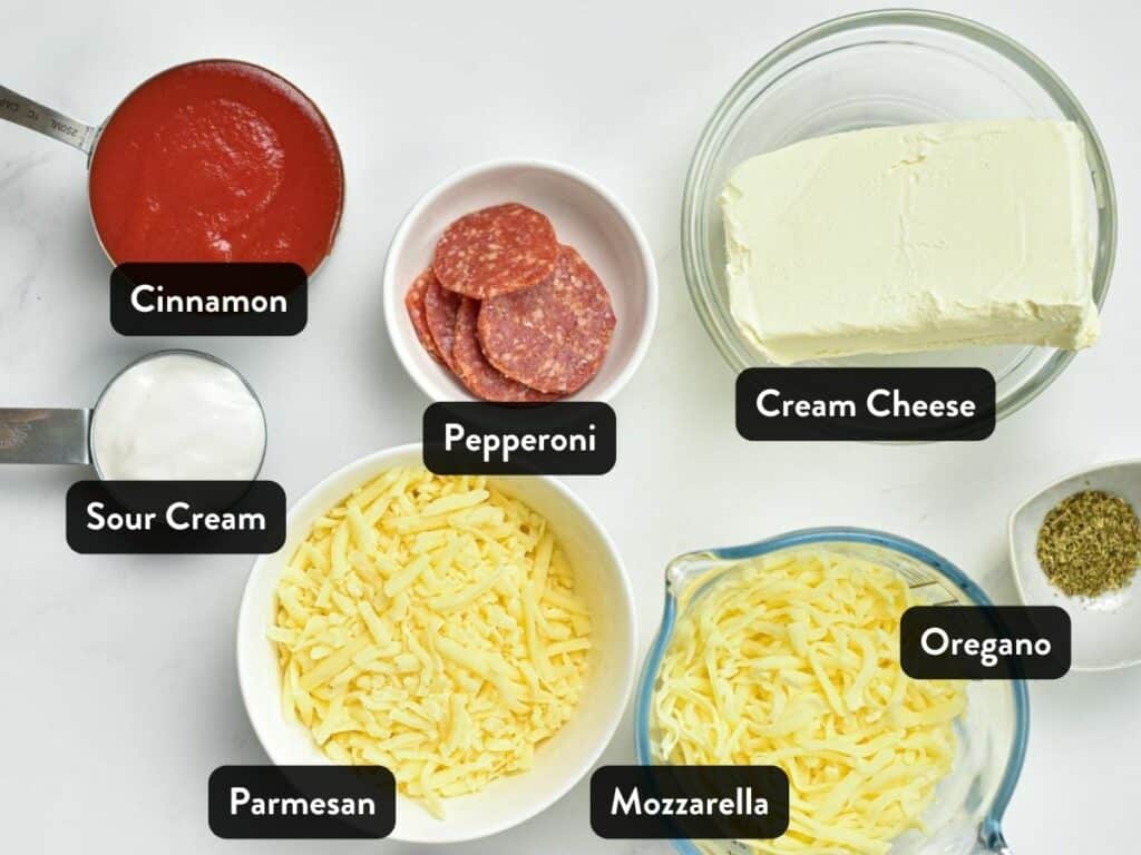 Ingredients for Keto Pizza Dip in various bowls and cups with labels.