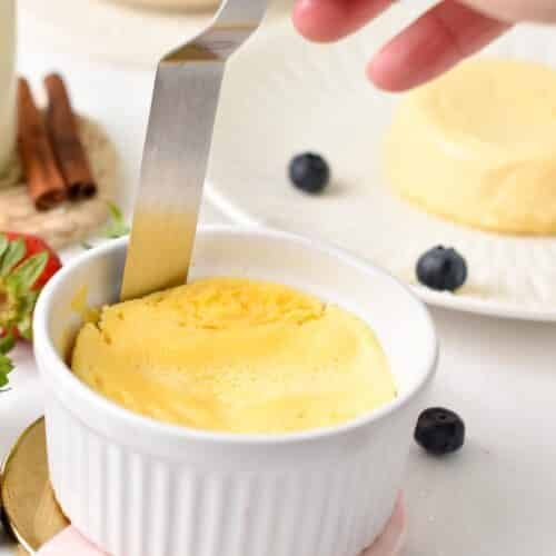 a knife running around the sides of a cheesecake in a ramekin