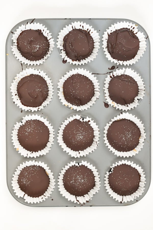 Twelve Keto Peanut Butter Cups  on the muffin tin.