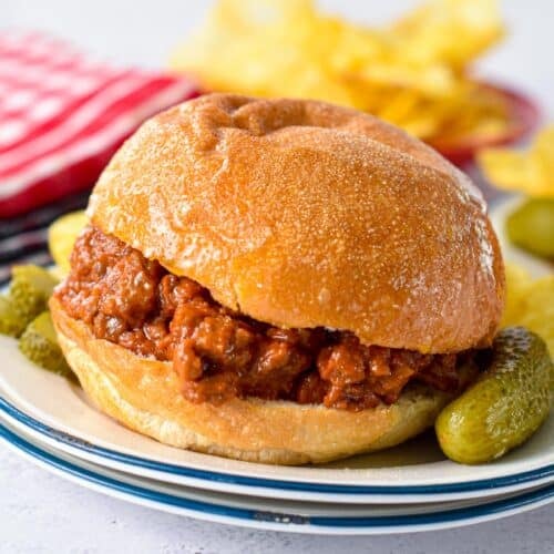 a low-carb bun filled with low-carb sloppy joe filling and gherkins on sides