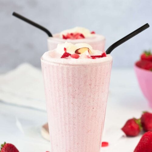 Keto Smoothies in two tall glasses with black metal straws.