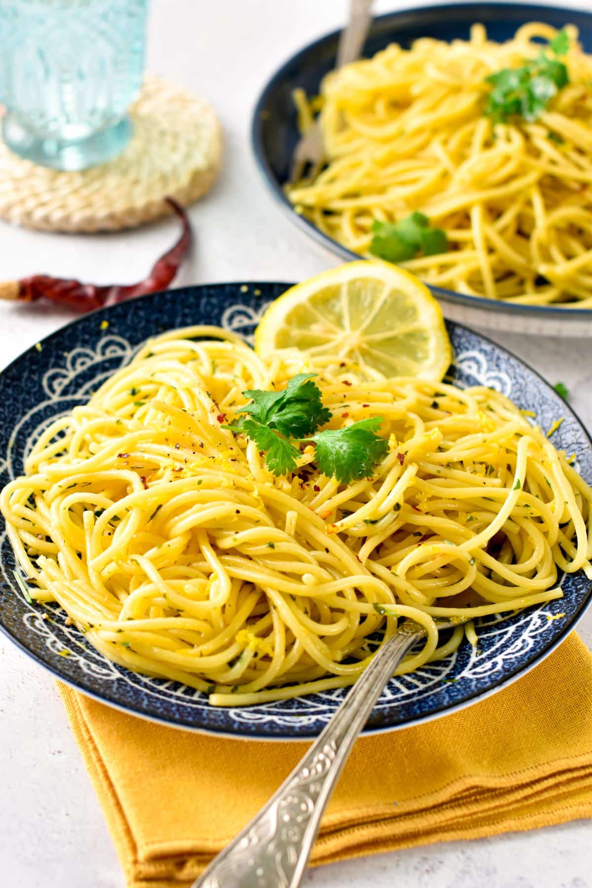 Lemon Garlic Pasta on a plate with a lemon slice.
