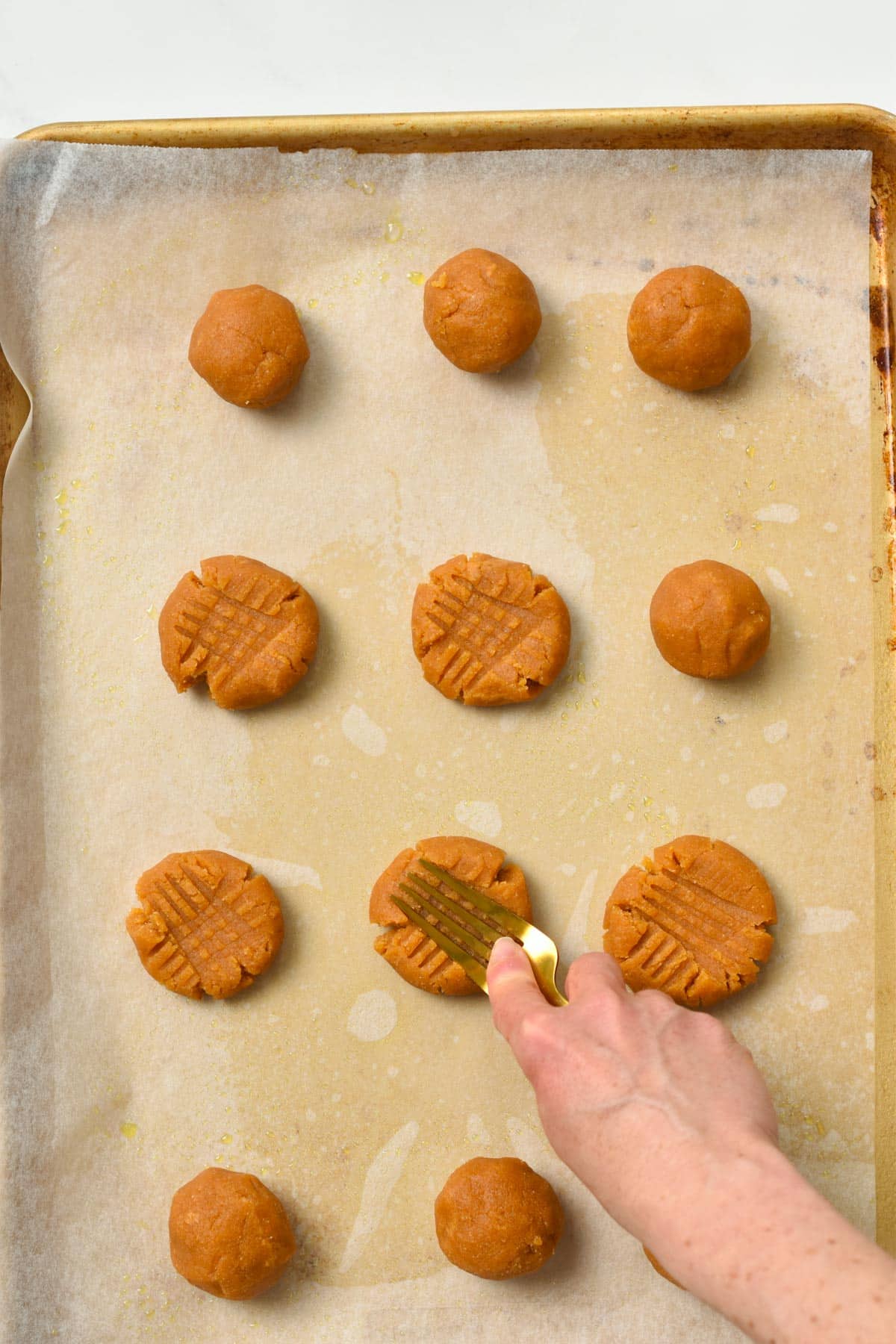 Making a crisscross patter on top of Peanut Butter With Coconut Flour