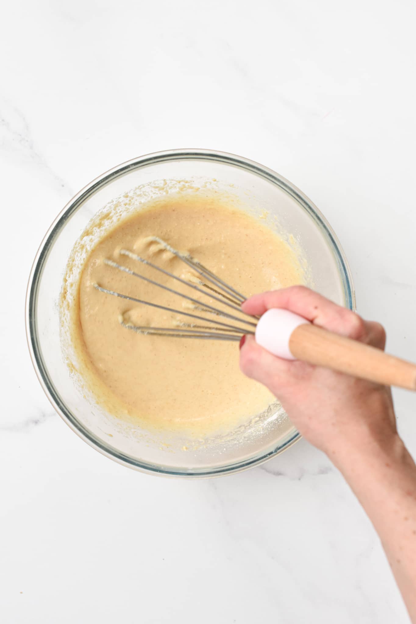 Making the Oat Flour Pancakes Batter by whisking the ingredients.