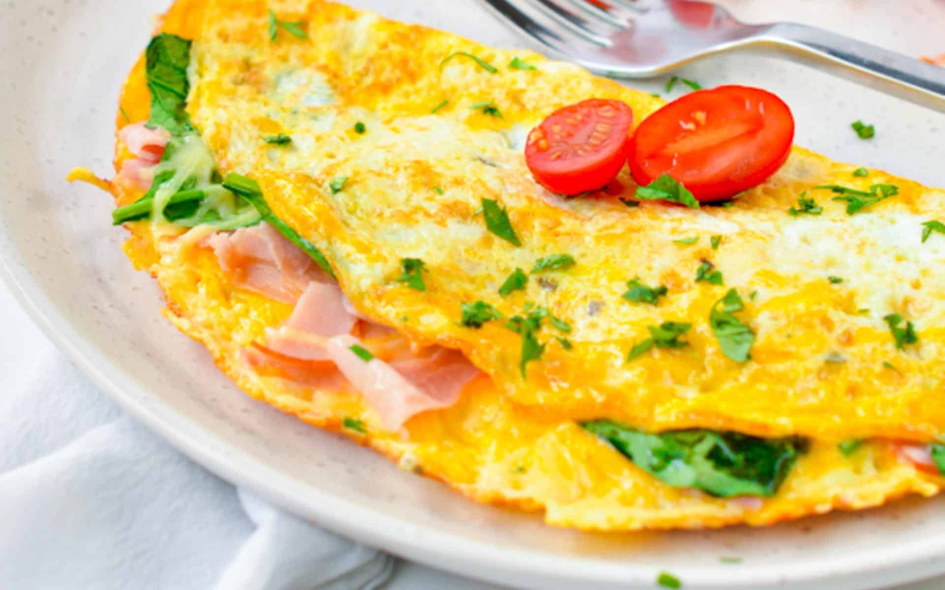 Healthy omelette filled with ham and spinach.