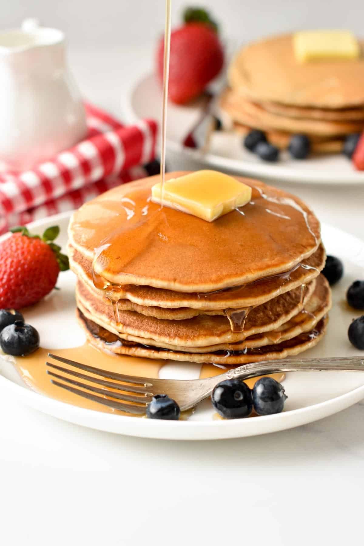 a stack of sugar-free Pancake with butter and drizzle of sugar-free syrup