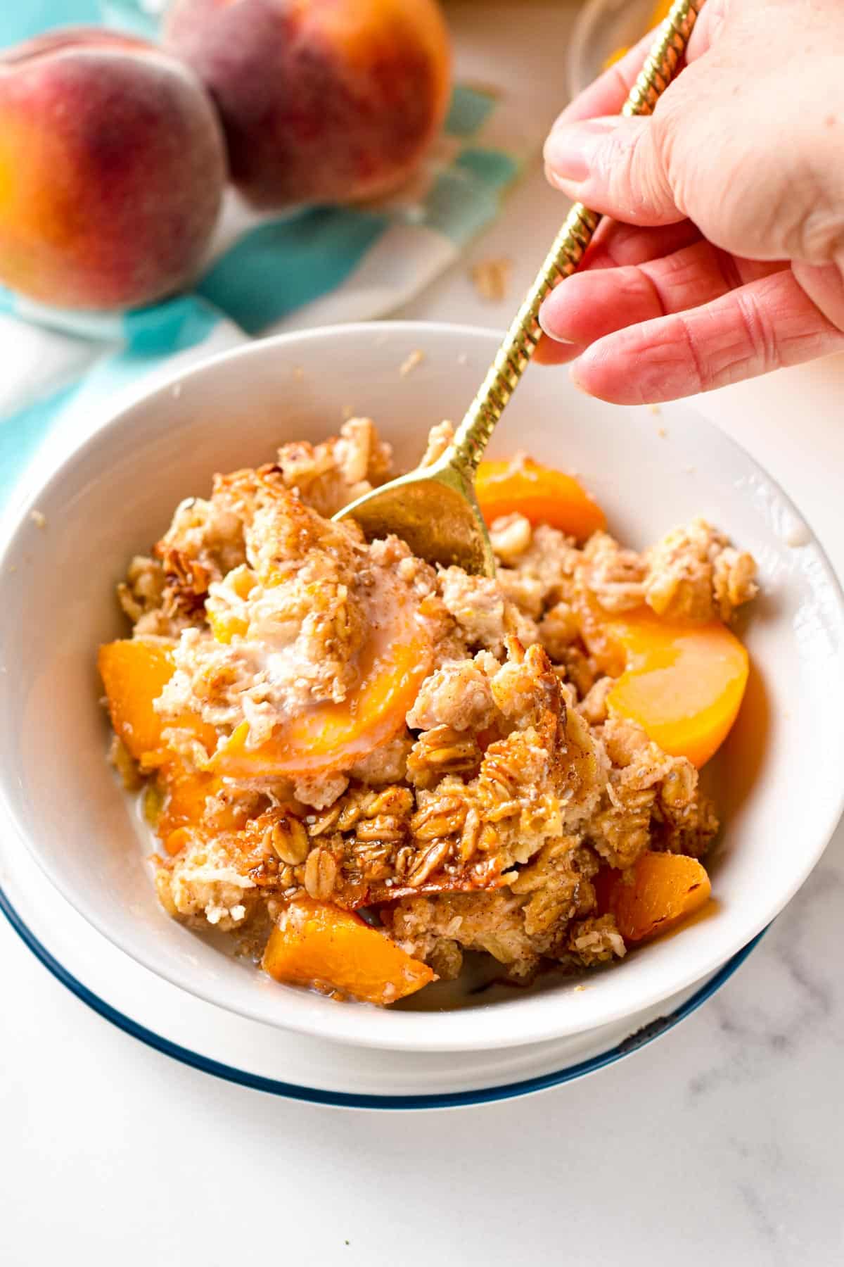 This Peach Baked Oatmeal isa creamy large batch of baked oatmeal filled with juicy peach. The perfect healthy family summer breakfast to use all your peaches this summer.