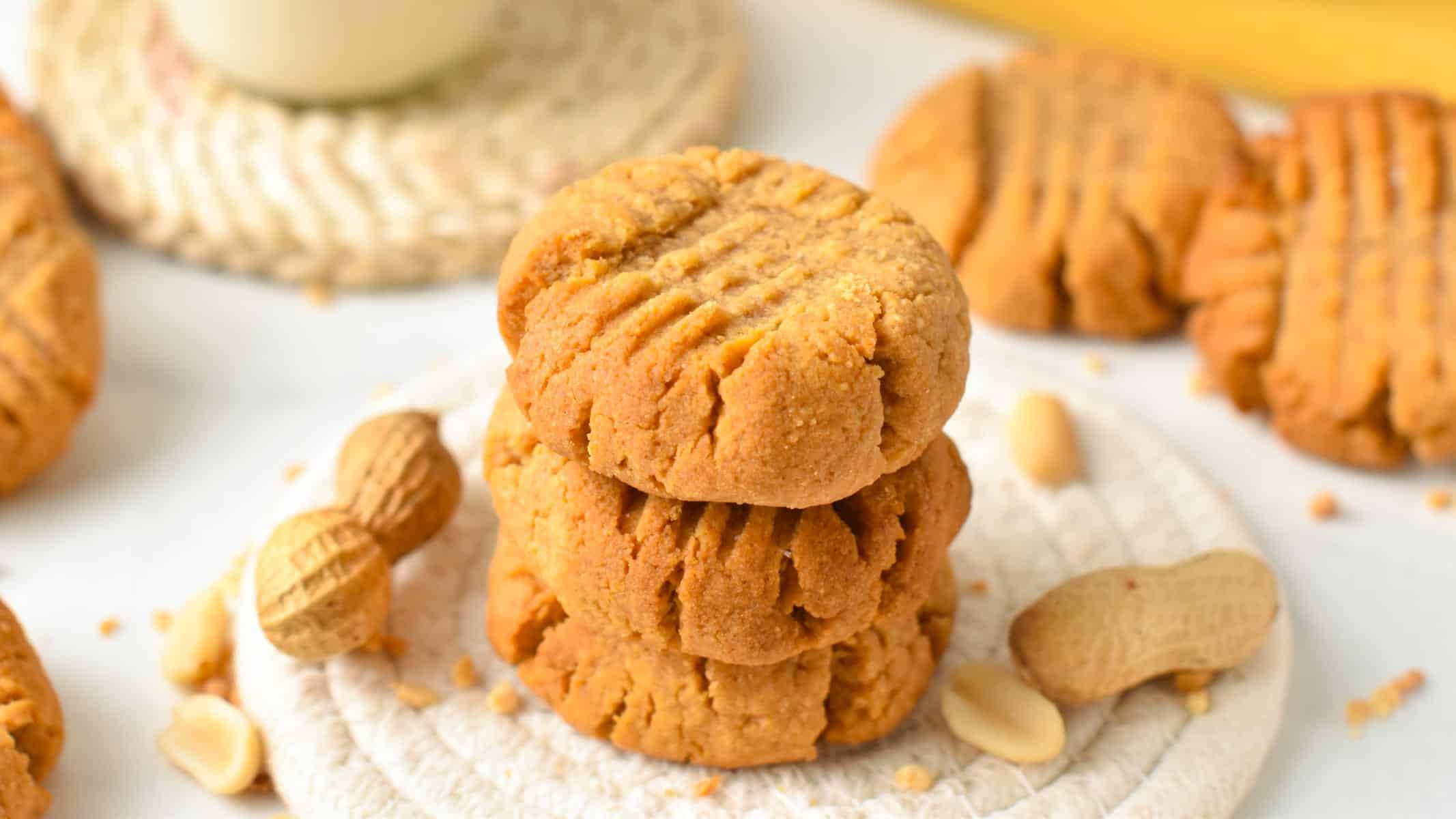 a stack of three peanut butter cookies with a crisscross pattern on top