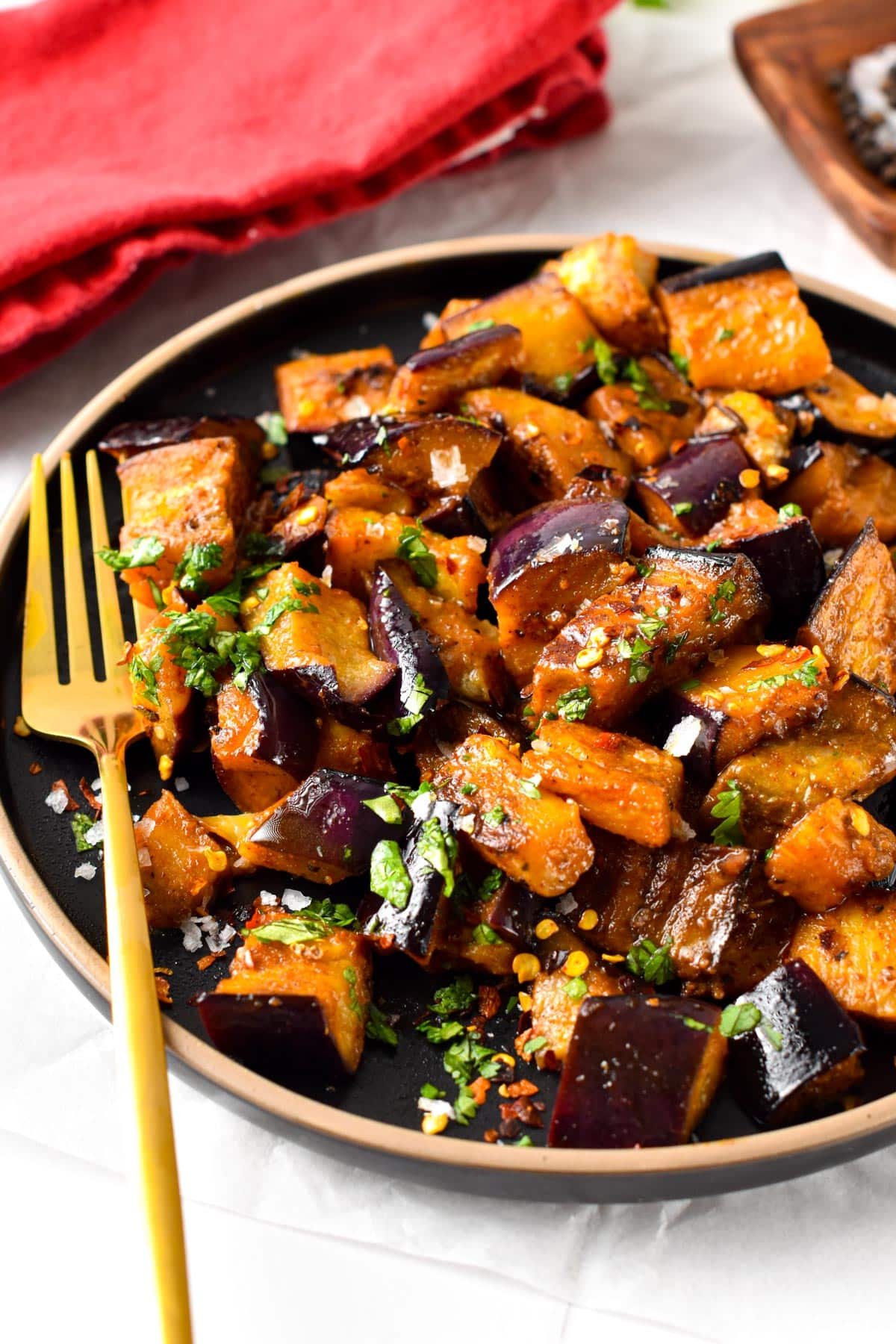 Learn how to turn eggplant into the best side dish this summer with this sauteed eggplant recipe. You will make everyone fall in love with these soft, tender, and caramelized pieces of pan-fried eggplant, on your next BBQ party.