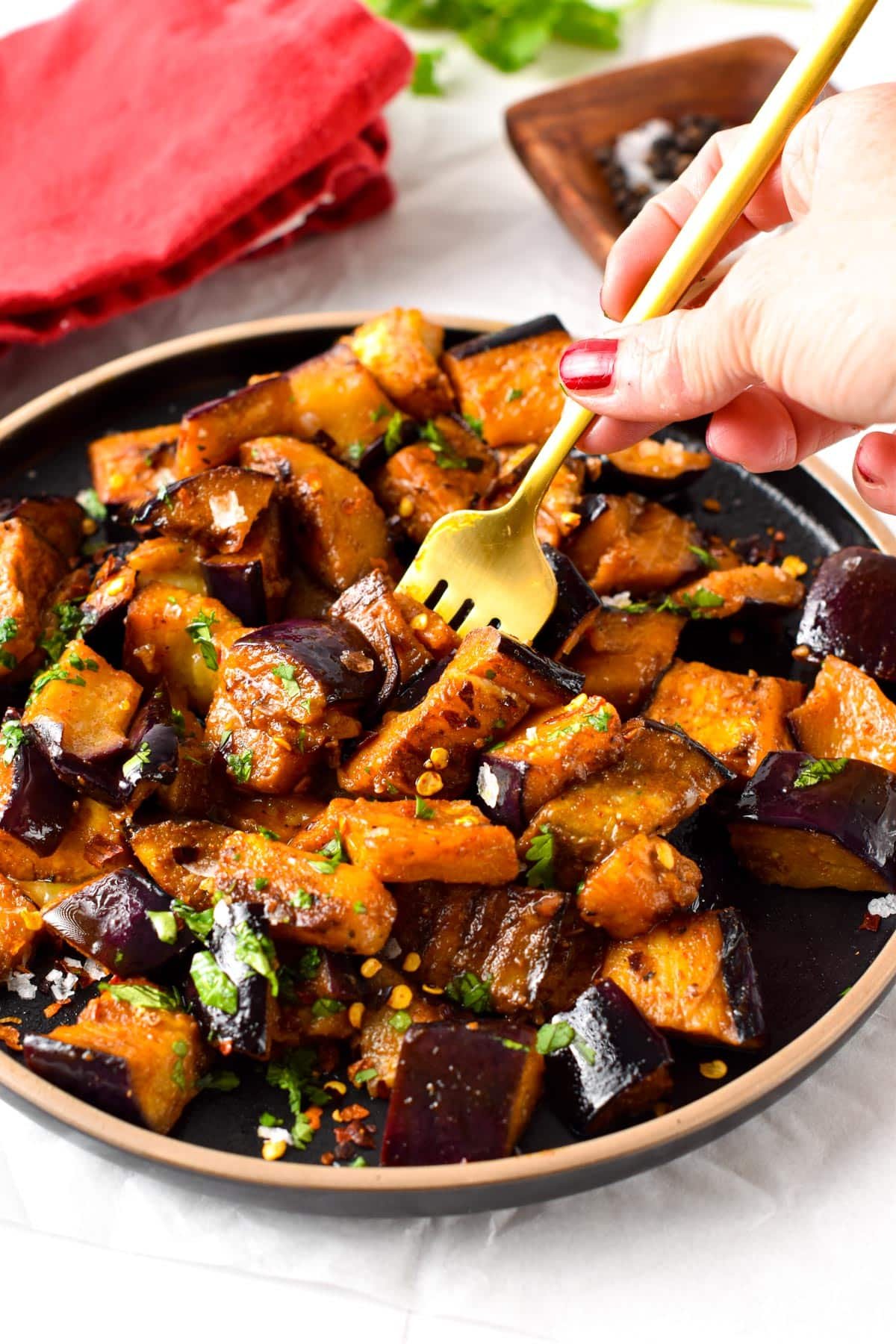 Learn how to turn eggplant into the best side dish this summer with this sauteed eggplant recipe. You will make everyone fall in love with these soft, tender, and caramelized pieces of pan-fried eggplant, on your next BBQ party.