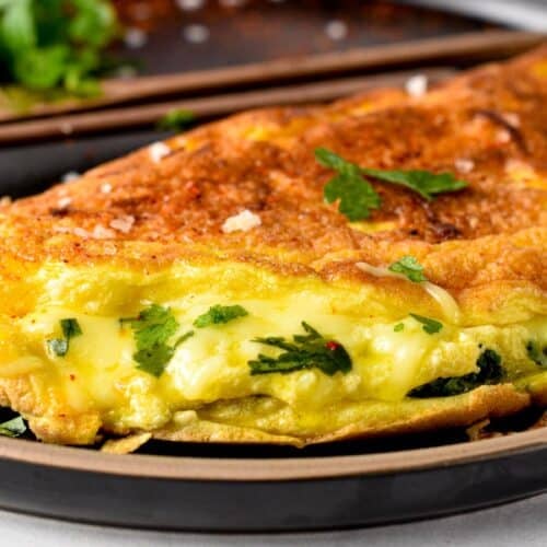 This souffle omelette is the perfect weekend breakfast a light, fluffy omelette with crispy edges and filled with herbs and cheese. Plus, this is a healthy breakfast packed with protein to keep you full for hours and it takes barely 15 minutes to make.