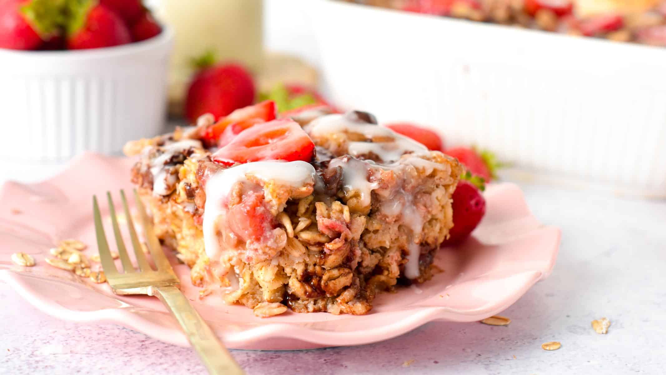 Slice of Strawberry Baked Oatmeal on a pink plate.