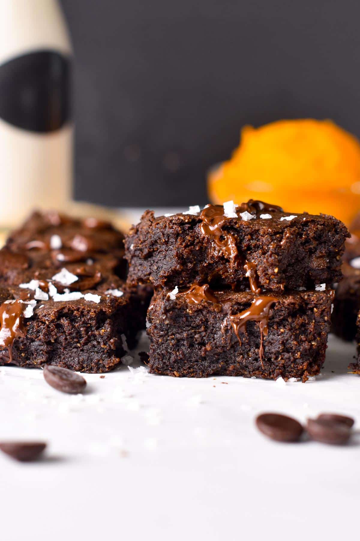 Sweet Potato Brownies stacked on a white table.