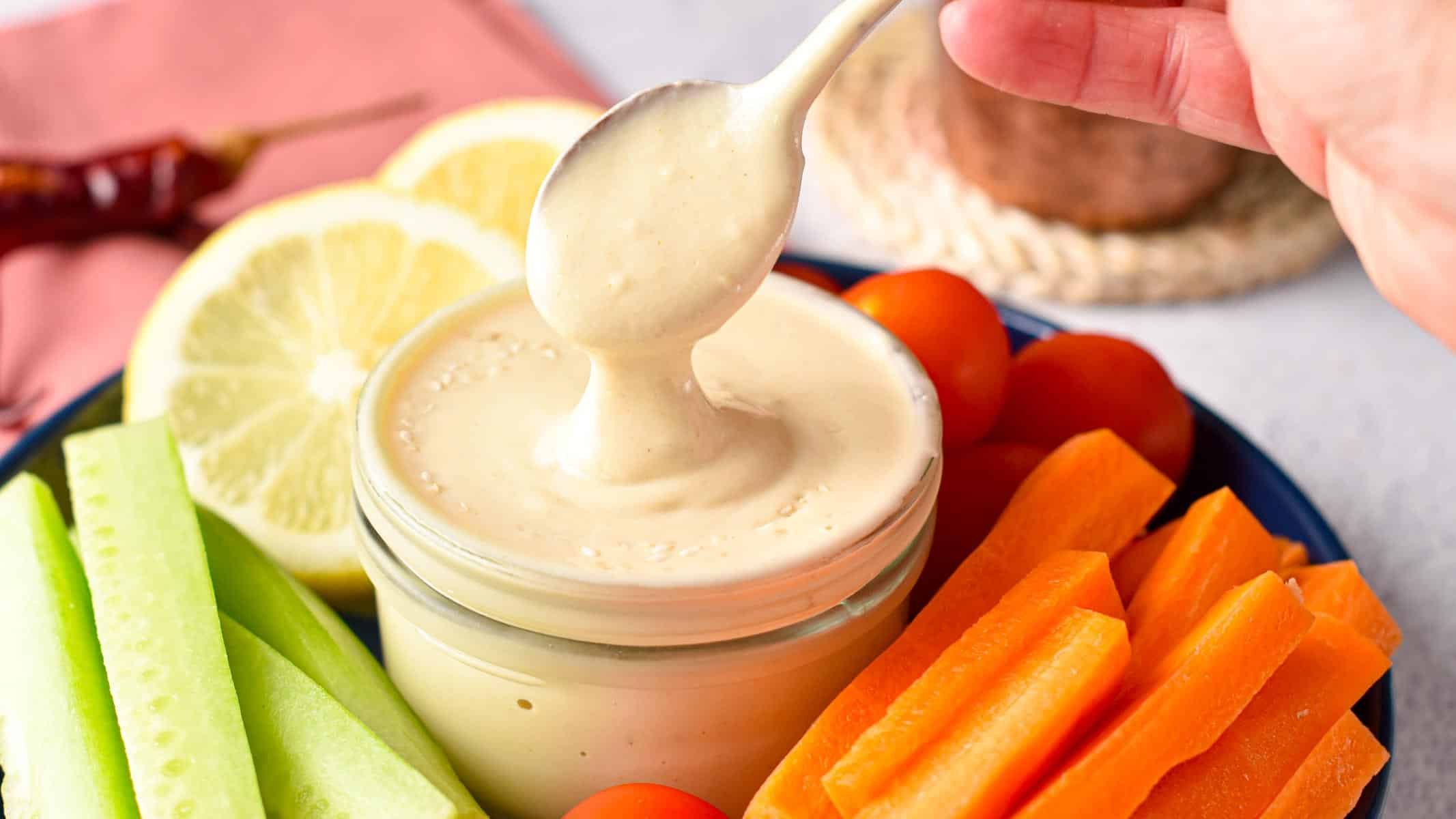 This Tahini Sauce is a creamy dairy-free sauce packed with plant-based proteins from sesame seeds and delicious on top of salad, roasted vegetables or as a tahini salad dressing.