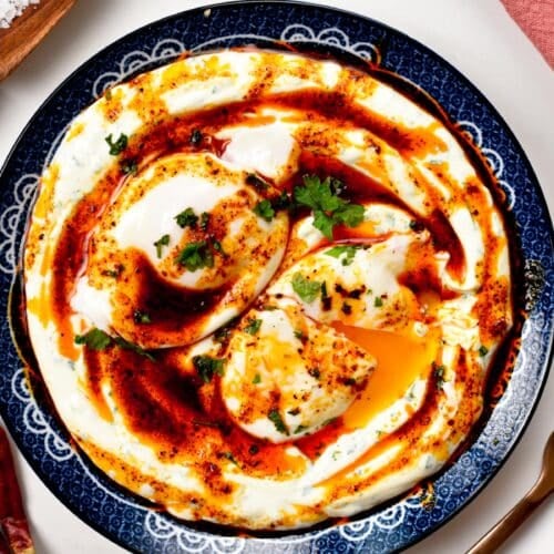 These Turkish Eggs also called Cilbir are the best high-protein low-carb breakfast ever packed with 25 g proteins. An ultra creamy garlic yogurt, topped with warm poached eggs and spicy Aleppo butter.