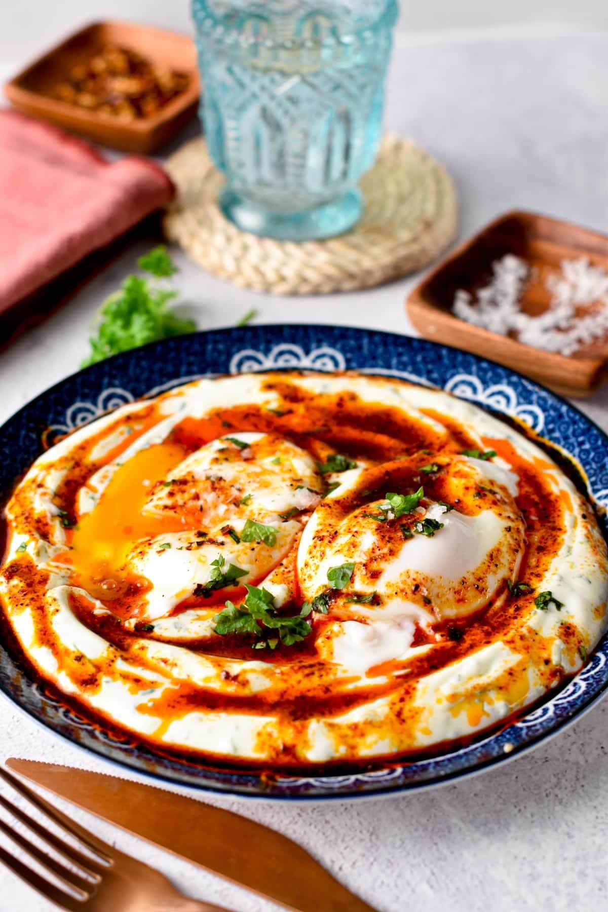 These Turkish Eggs also called Cilbir are the best high-protein low-carb breakfast ever packed with 25 g proteins. An ultra creamy garlic yogurt, topped with warm poached eggs and spicy Aleppo butter.