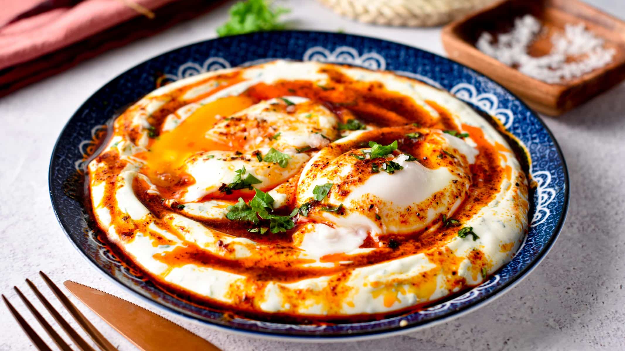 These Turkish Eggs also called Cilbir are the best high-protein low-carb breakfast ever packed with 25 g proteins. An ultra creamy garlic yogurt, topped with warm poached eggs and spicy Aleppo butter.