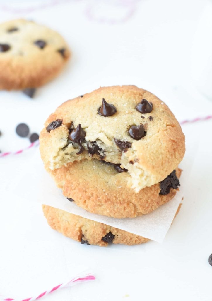 Vegan Keto Cookies With Chocolate Chips stacked on a white table.