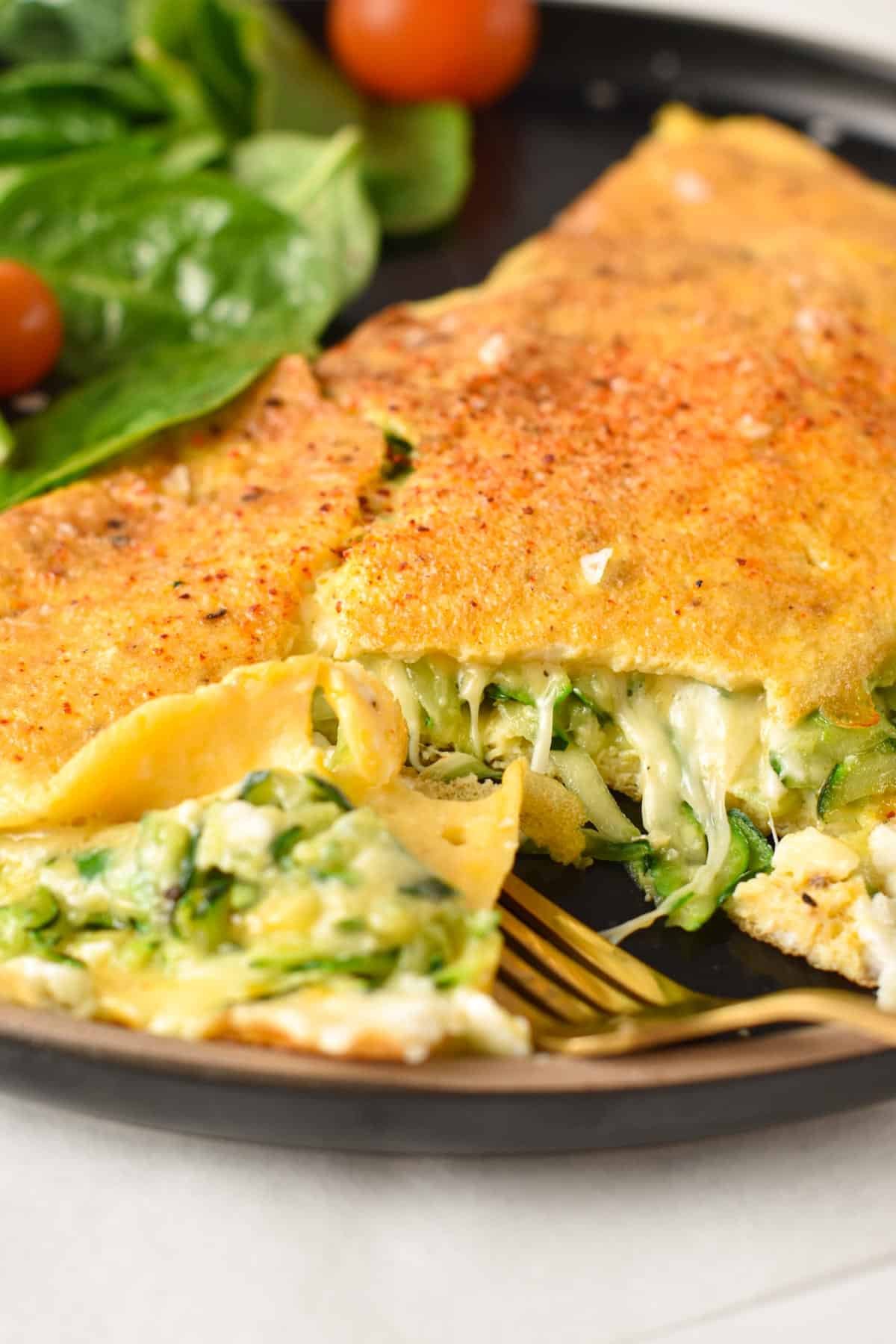 An omelette filled with grated zucchini and cheese.