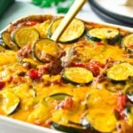 This Zucchini Sausage Casserole is an easy and healthy family dinner to use for your summer zucchini. Delicious crunchy zucchini slices, cooked in a homemade tomato sauce with tasty pieces of ground sausage.