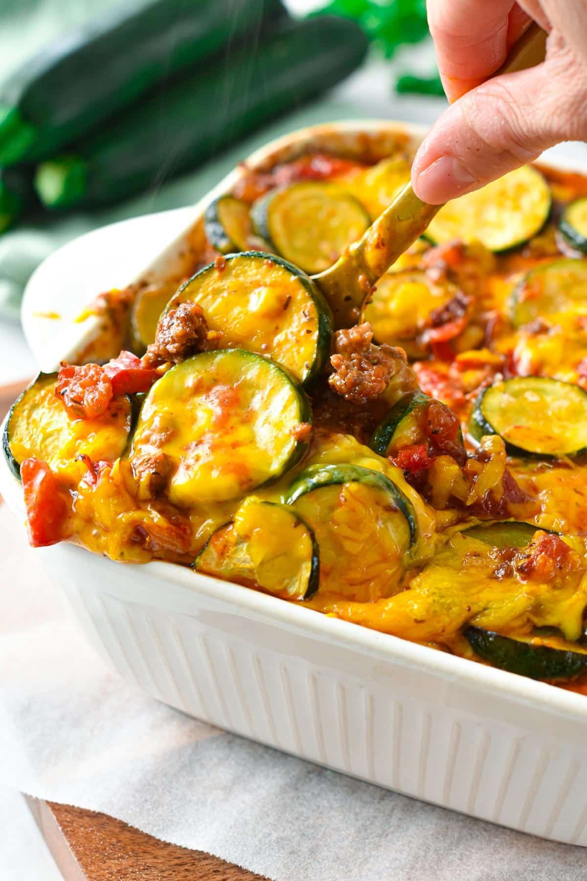 This Zucchini Sausage Casserole is an easy and healthy family dinner to use for your summer zucchini. Delicious crunchy zucchini slices, cooked in a homemade tomato sauce with tasty pieces of ground sausage. 