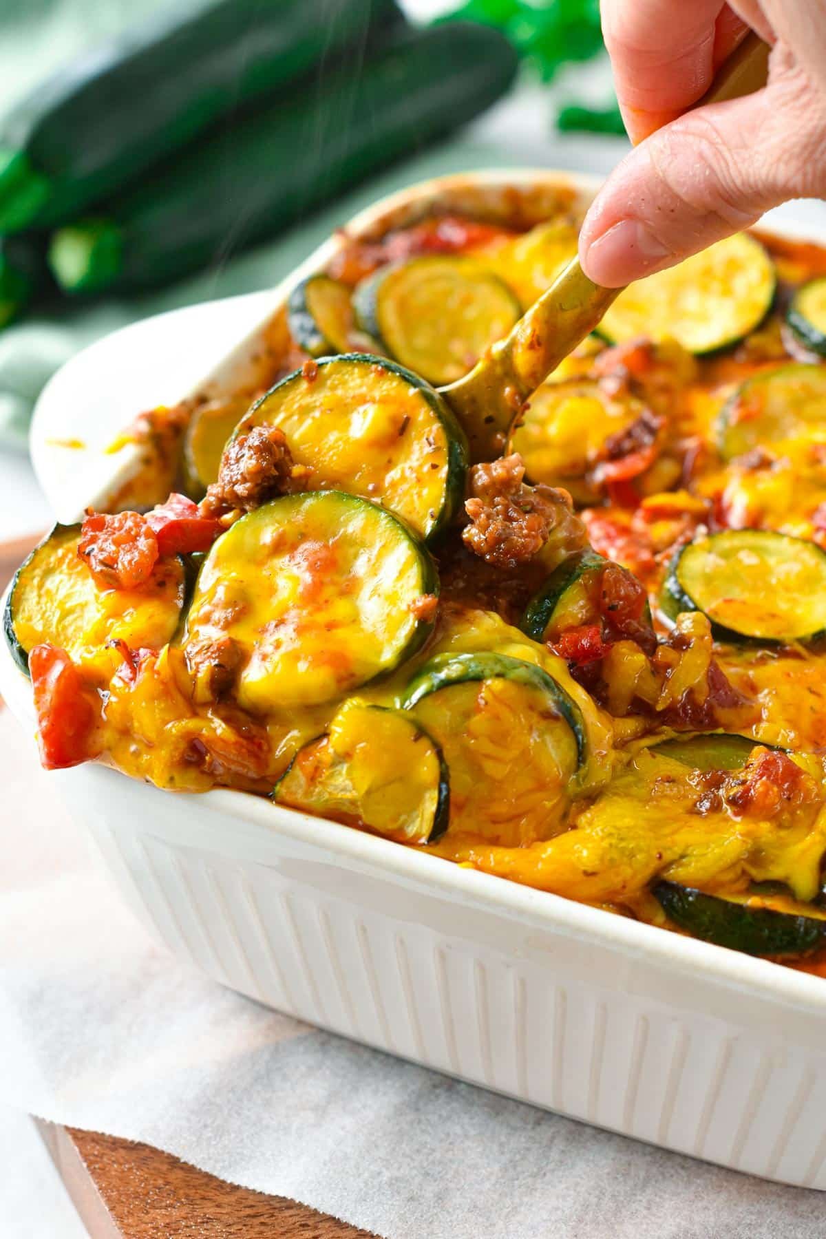 Big spoon digging into Zucchini Sausage Casserole.